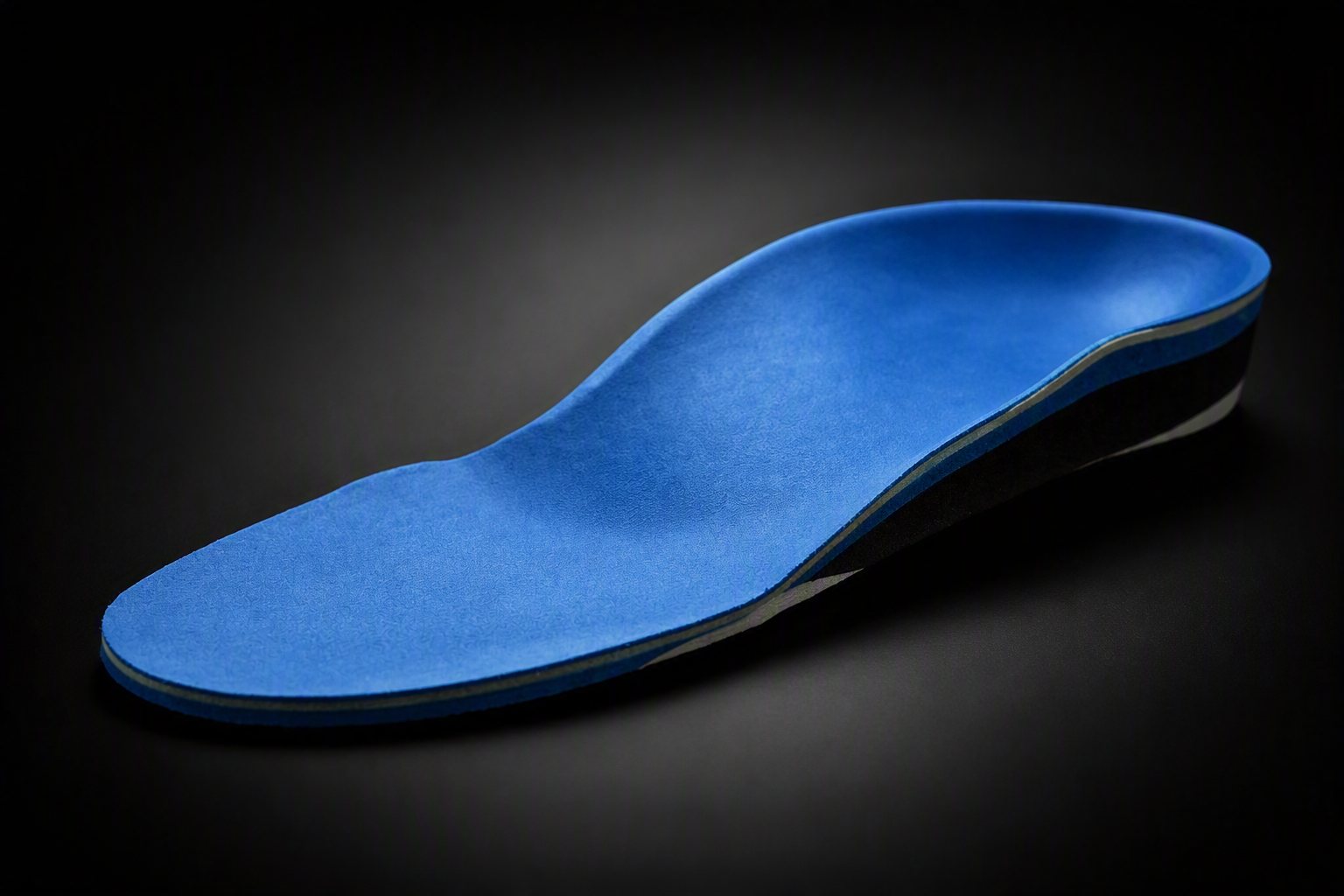 A custom orthotic with a blue top cover